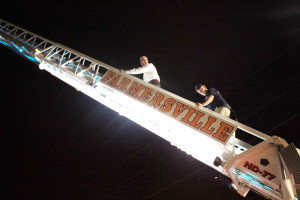 Farmersville City Manager Ben White climbs the ladder truck with the assistance of Farmersville FD Captain Barry Pollard.
