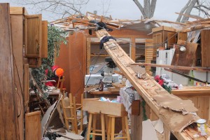Charlie and Le Ann Peters survived the EF2 tornado which demolished their house while huddled inside their bathroom. The house is located on a county road outside Farmersville.