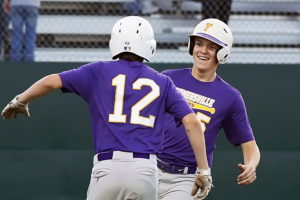 Braxton Hacker (12) welcomes Michael Bagwill (5) after the late scores what turned out to be the winning run in Game 2 last week’s regional quarterfinal against Grand Saline. Farmersville clinched the series the following day with a 9-0 victory.